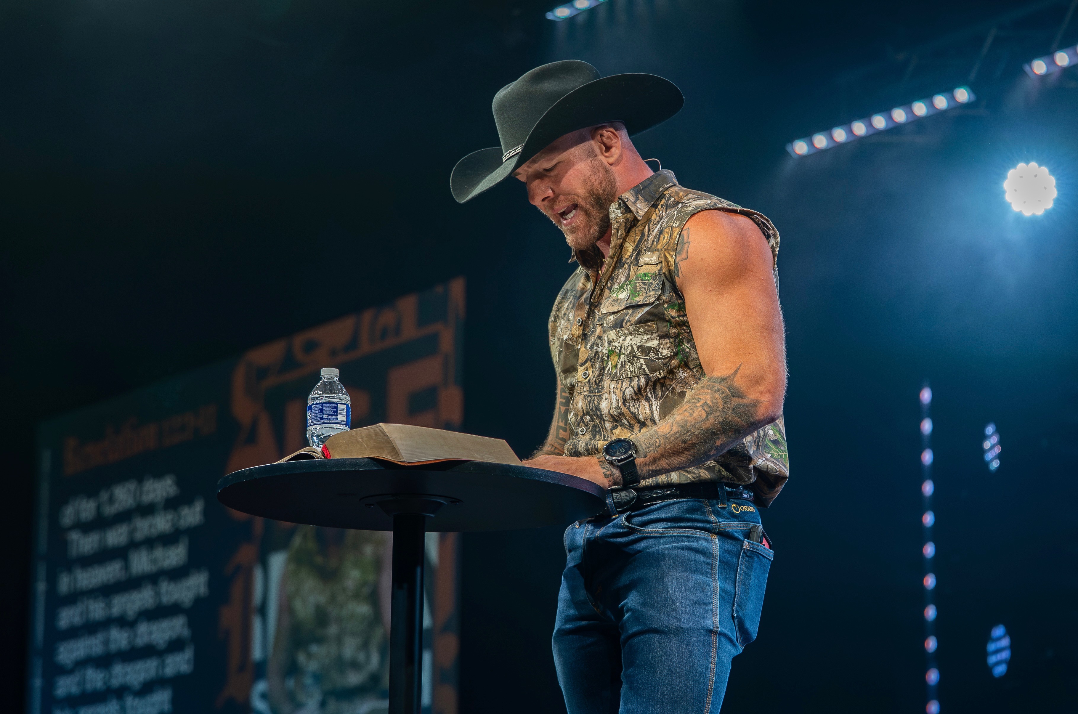 Mike preaching from Revelation in a black cowboy hat and camo